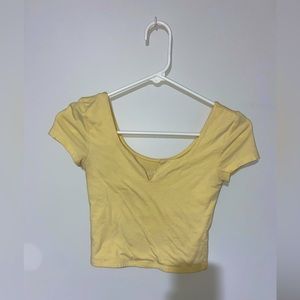 This is a baby yellow cropped t-shirt.